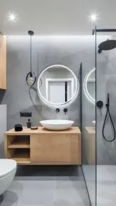 Modernes Badezimmer mit Holzwaschtisch, rundem LED-Spiegel und Walk-in-Dusche in grau-schwarzem Design