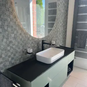 Modernes Waschbecken auf Badmöbel mit dunkler Platte und strukturierter Fliesenwand hochwertige Badsanierung Marl